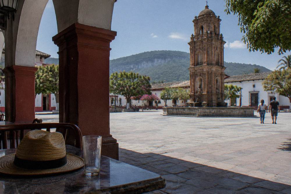 Colonial arcades and fountain square of a small Chiapas town at midday