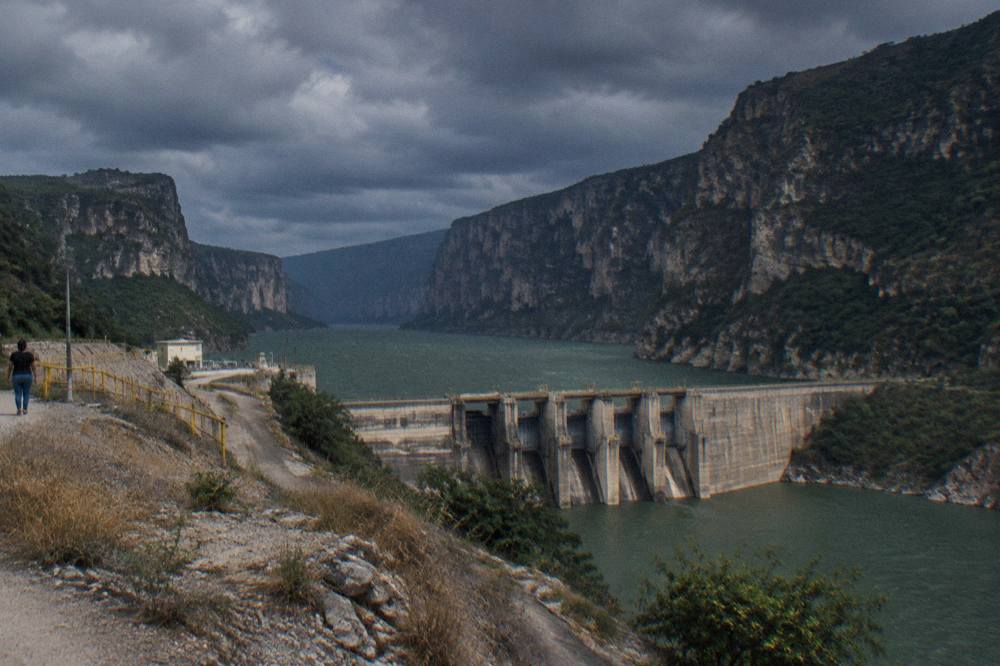 Dark storm clouds gathering over the green walls of Sumidero Canyon