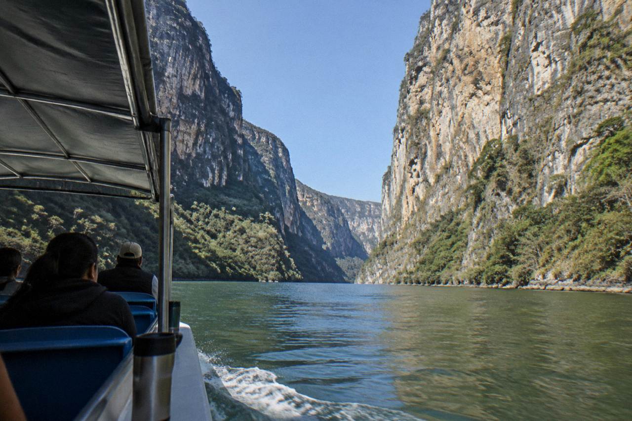 Walls of Sumidero Canyon rising above the Grijalva River under a clear morning sky