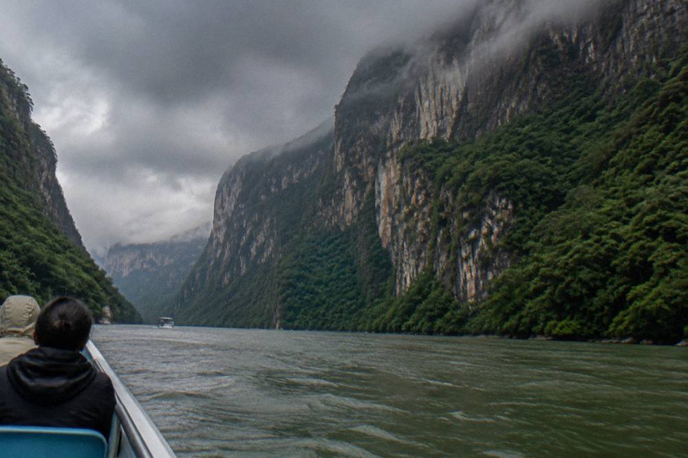 Dark rain clouds gathering above the green slopes of the canyon in the rainy season
