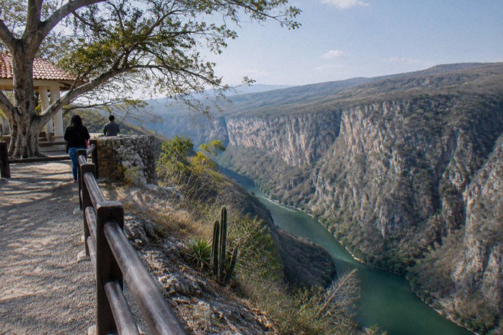 Viewpoint platform overlooking the deep gorge of the Grijalva River and canyon walls