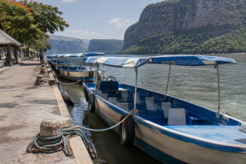 Shared boats moored at a riverside dock waiting for passengers