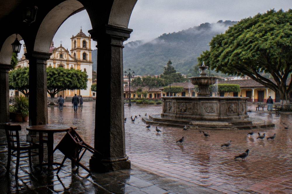 Colonial arcade and brick fountain in the main plaza of a small Mexican town