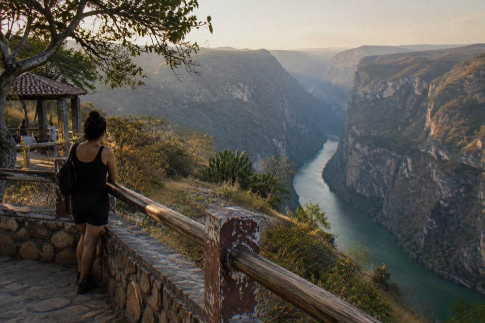 Panoramic view from a canyon rim viewpoint across the Grijalva River gorge in late afternoon