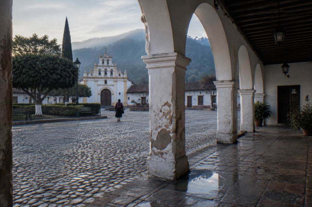 Colonial arcade and central plaza of a highland Mexican town in early morning