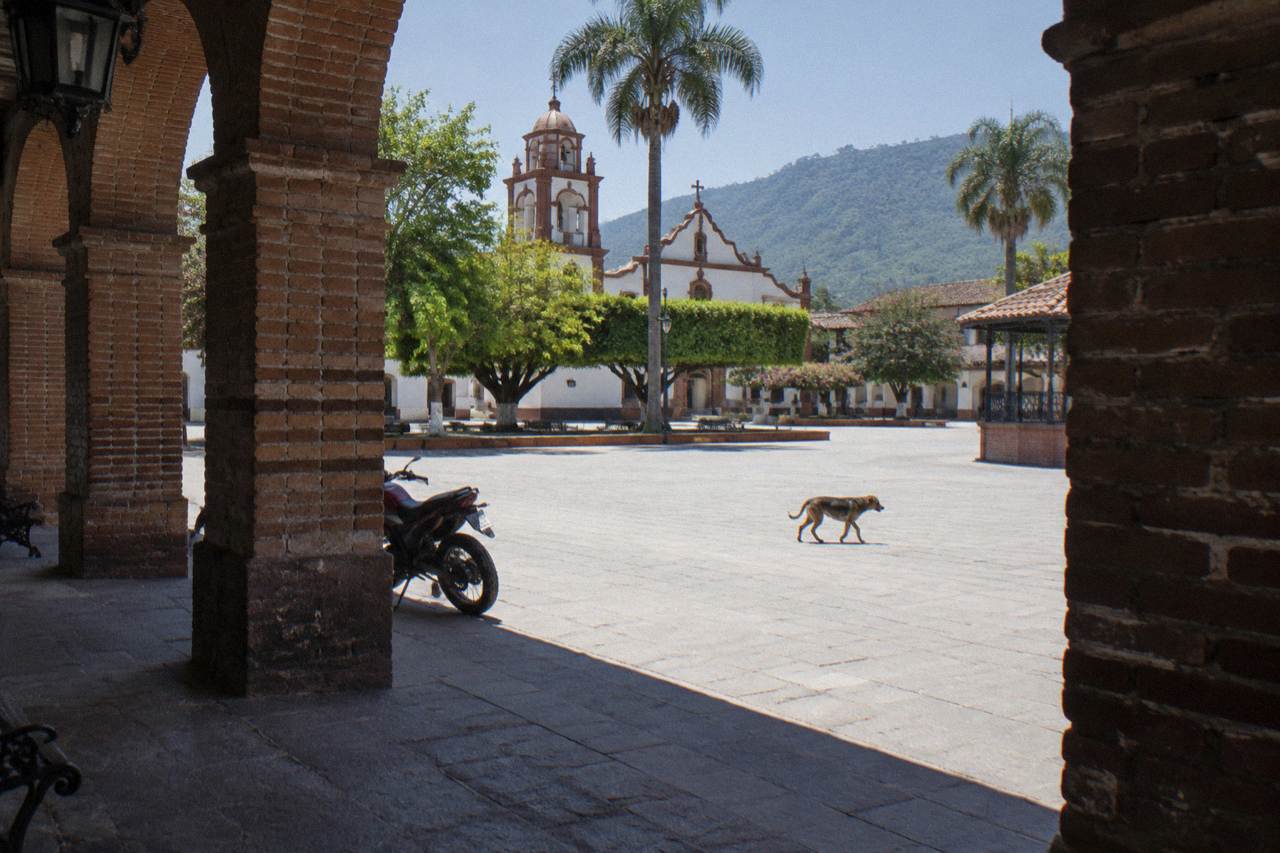 Colonial arcade and plaza in a southern Mexican town at midday
