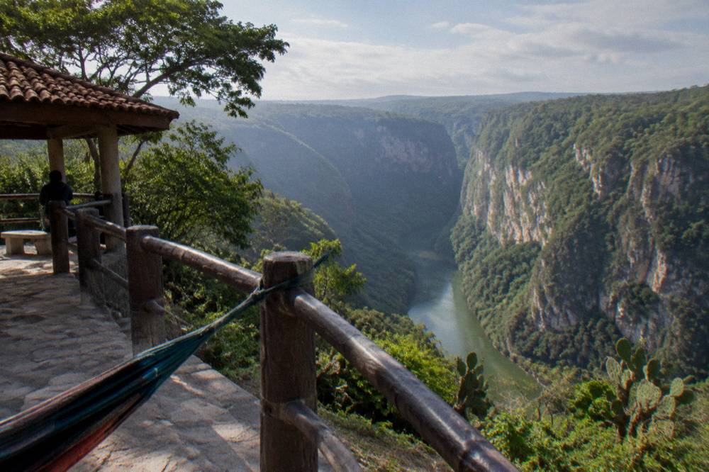 Viewpoint platform above a deep canyon with a river winding below