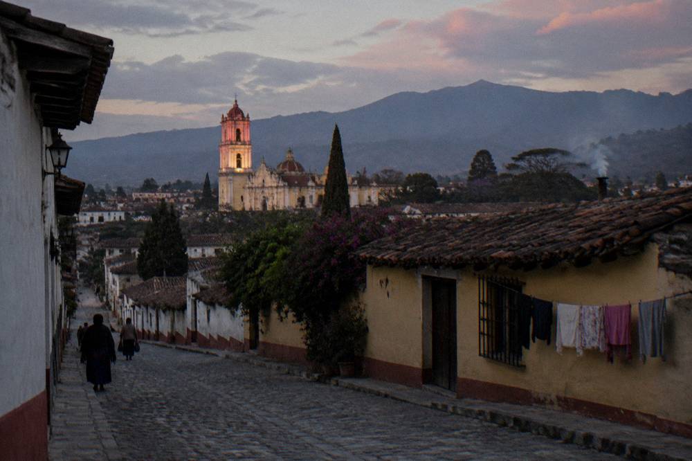 Mountain town rooftops and church towers at dusk in the Chiapas highlands
