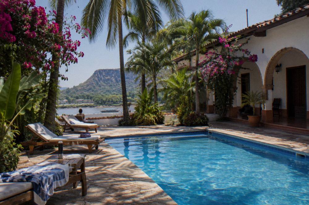 Sunny hotel garden with a pool and palms in Chiapa de Corzo